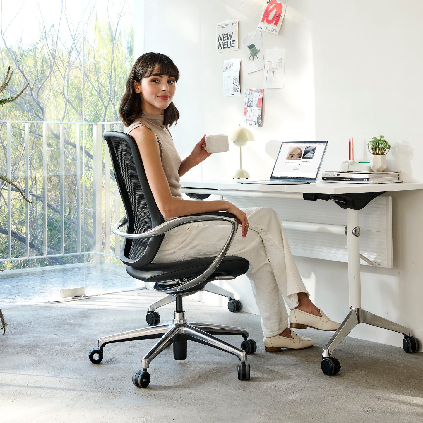 A young lady is sitting on the Nexa chair in home office