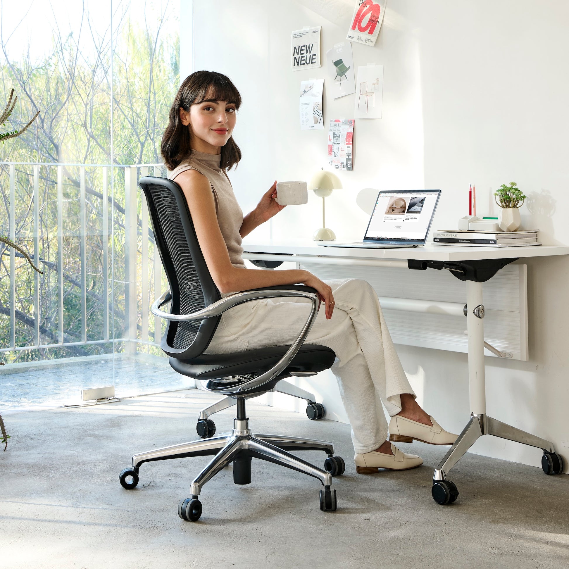 A young lady is sitting on the Nexa chair in home office