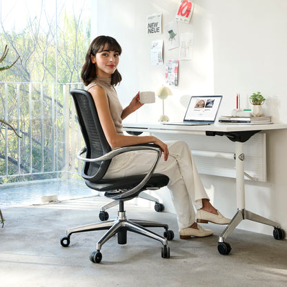 A young lady is sitting on the Nexa chair in home office